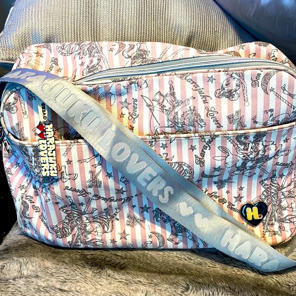 Pick and white striped Harajuku Lovers bag.  Gray adjustable strap